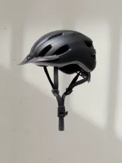 Animated image showing a bike helmet rotating clockwise around a central image of a cyclist, then moving into an empty space in a retailer catalog. The words 'Connect, Share, Sell' rotate to demonstrate how suppliers use PlatformDTC Collective to connect and share products with retailers who import and sell them.