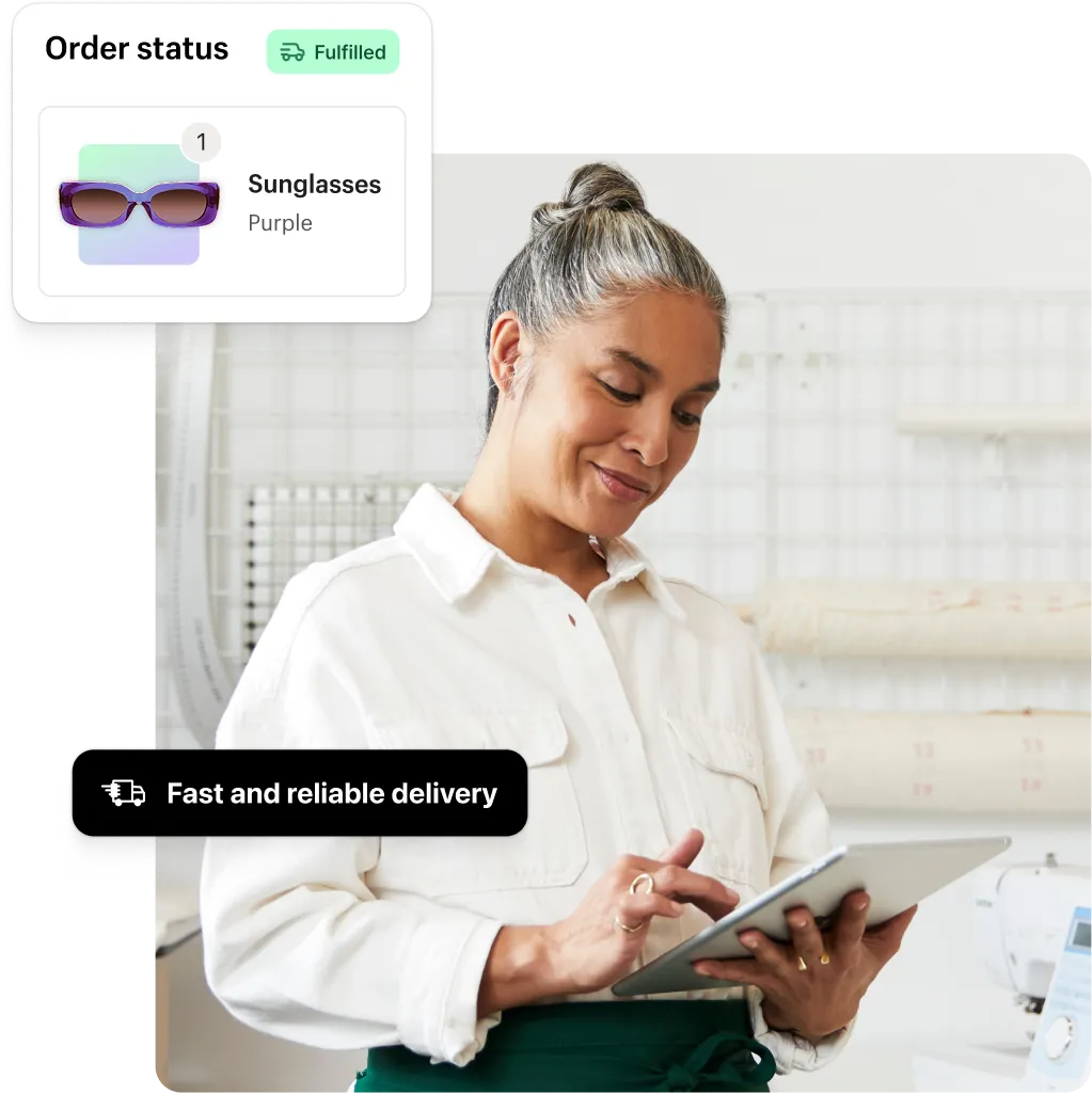 A business owner using a tablet to check orders, with graphics showing sunglasses fulfilled with fast and reliable shipping.