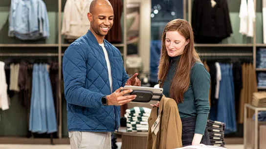 A store associate assisting a customer using PlatformDTC POS.