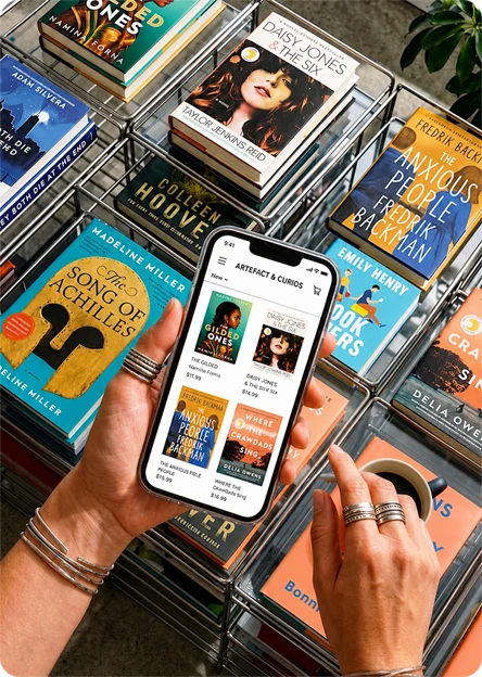 Person using their phone to find the right cookbook