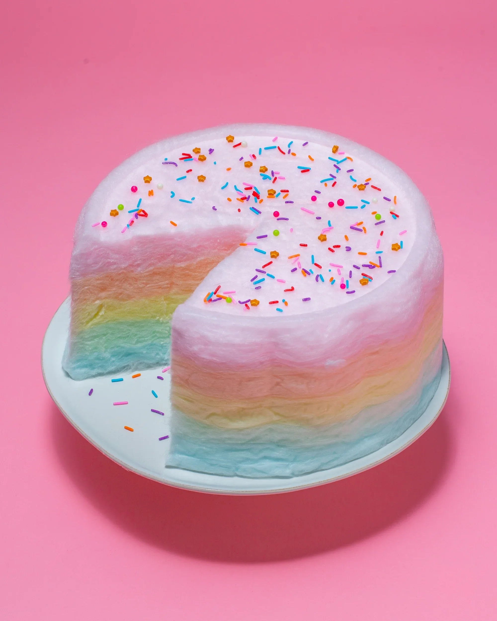 A card highlighting PlatformDTC merchant Floof, featuring a colorful cake with a slice cut out of it.