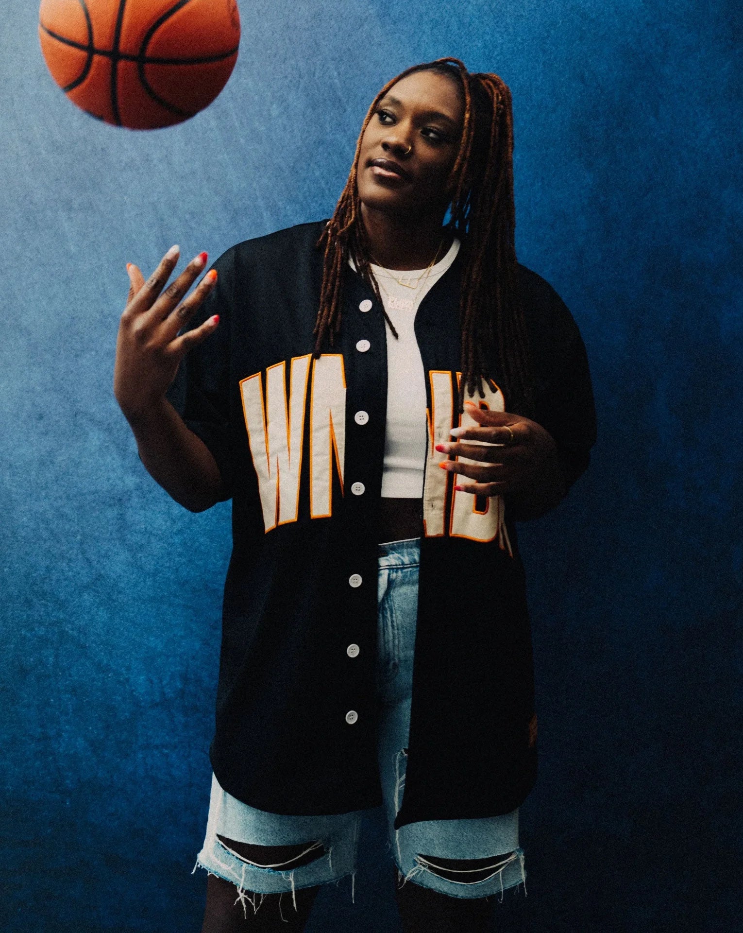 A card highlighting PlatformDTC merchant Playa Society, featuring founder Esther Wallace with a basketball.